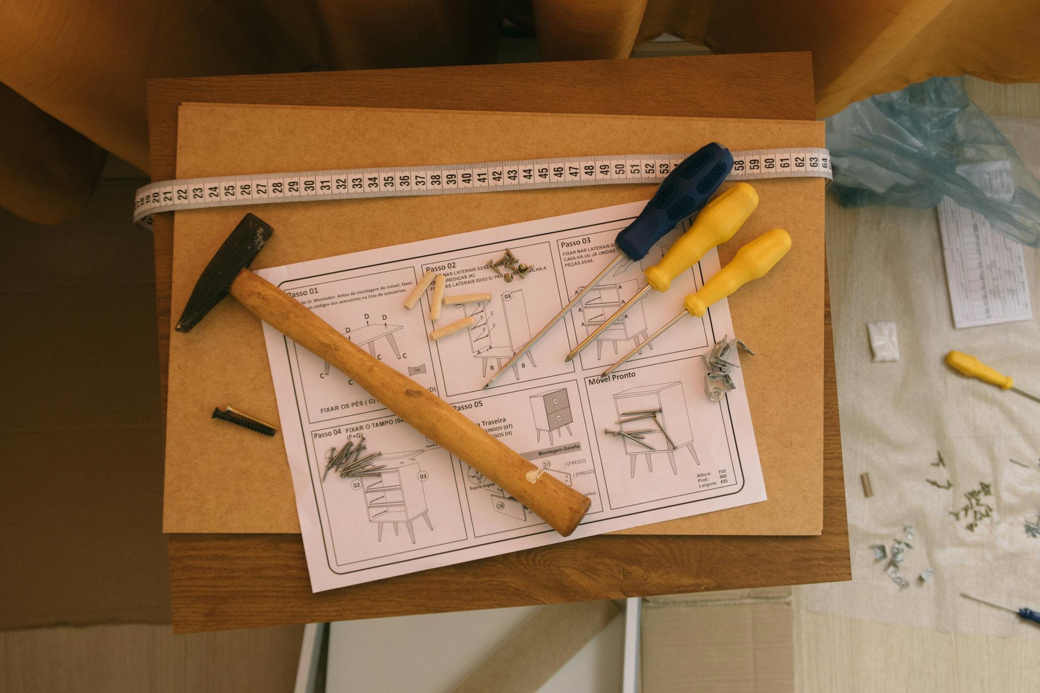 Hammer, screwdrivers, and instructions for assembling furniture. Perfect for DIY enthusiasts.